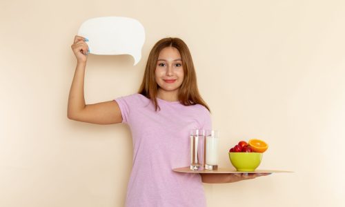 front-view-young-female-pink-t-shirt-holding-tray-fruits-milk-water-grey