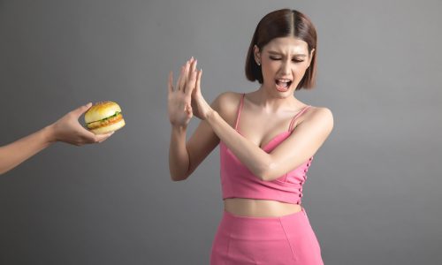 woman refusing junk food and prefer healthy food